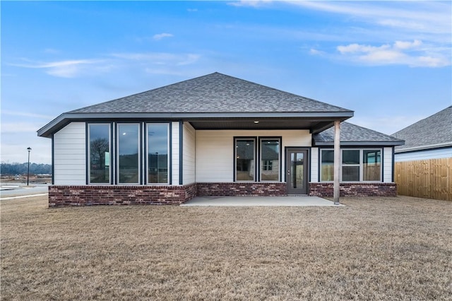 back of property with a patio and a lawn