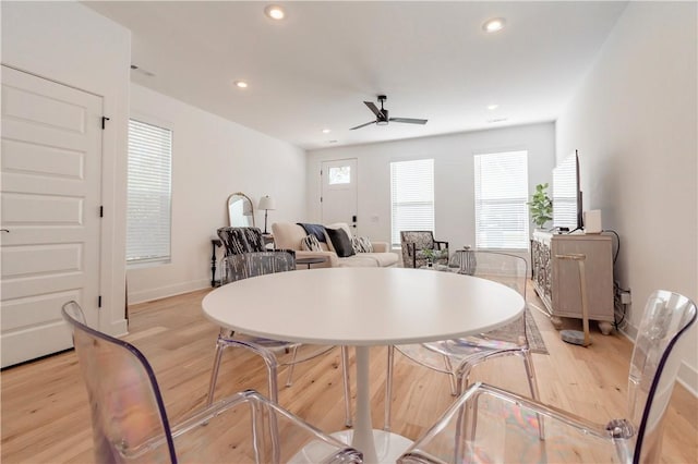 dining space with ceiling fan, a healthy amount of sunlight, and light hardwood / wood-style floors