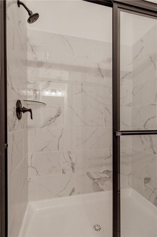 bathroom with tiled shower