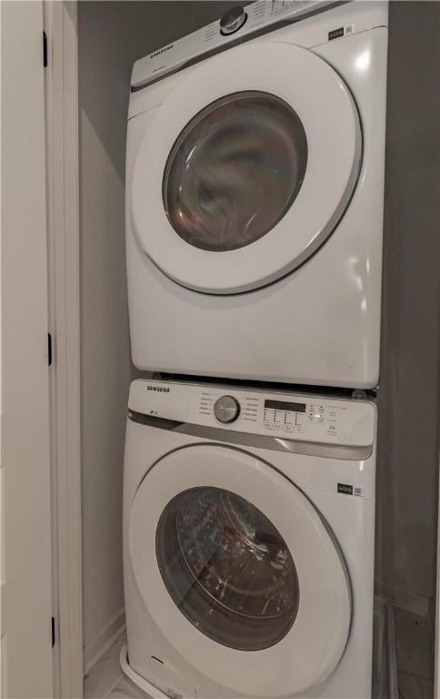 laundry area with stacked washer and clothes dryer