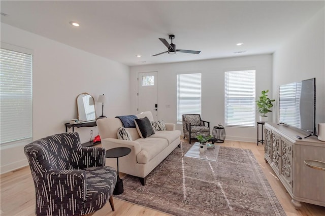 living room featuring ceiling fan and light wood-type flooring