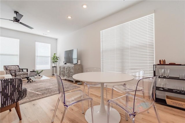 dining space featuring ceiling fan and light hardwood / wood-style floors