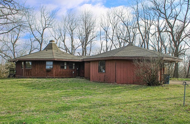 view of side of property with a lawn