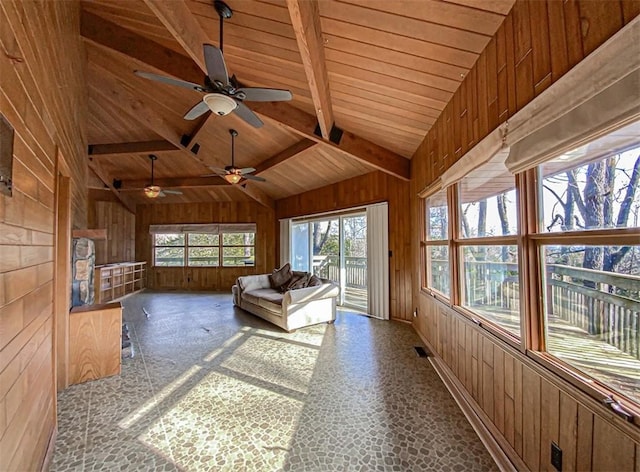 unfurnished sunroom featuring ceiling fan, lofted ceiling with beams, and wooden ceiling