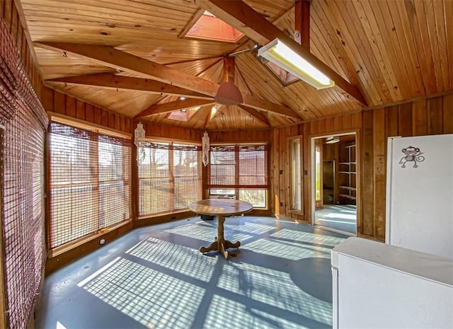 unfurnished sunroom featuring wooden ceiling, vaulted ceiling with skylight, and a jacuzzi