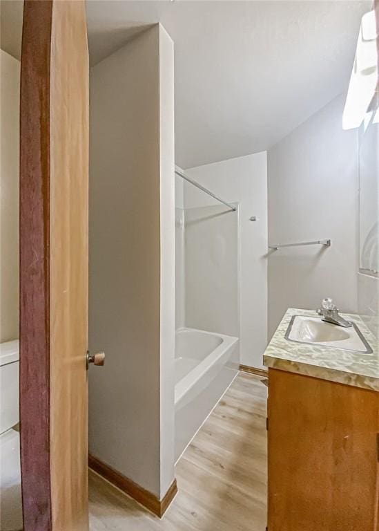 bathroom featuring hardwood / wood-style floors, vanity, and toilet