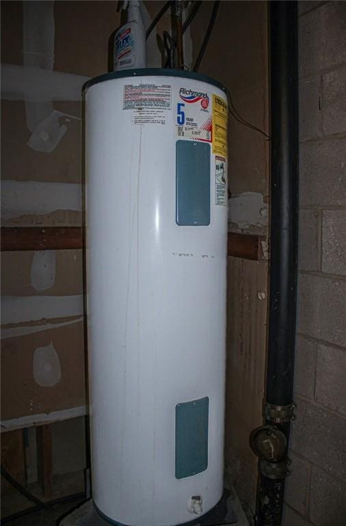 utility room featuring water heater