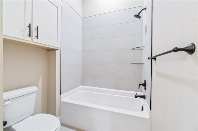 bathroom featuring toilet and tiled shower / bath