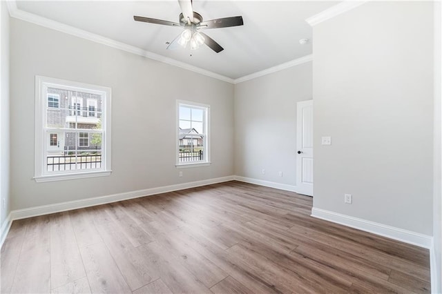 unfurnished room with ceiling fan, hardwood / wood-style floors, and crown molding