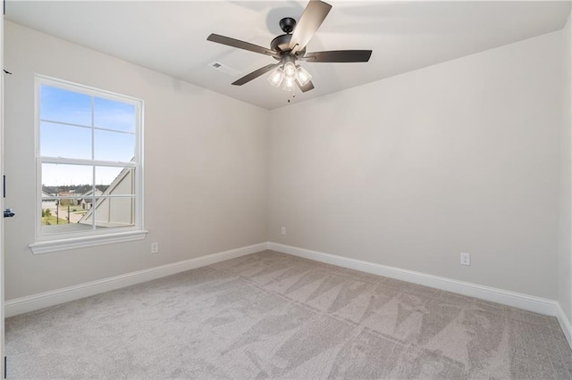 carpeted spare room featuring ceiling fan