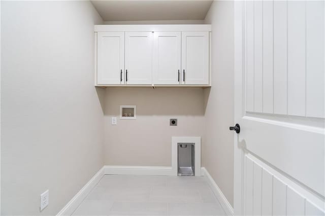 washroom featuring light tile patterned flooring, electric dryer hookup, washer hookup, and cabinets