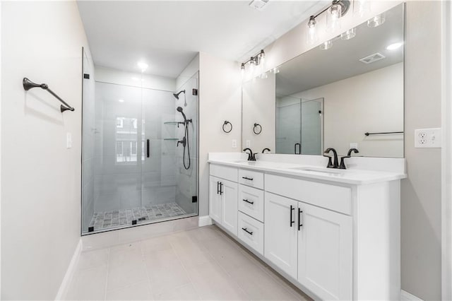 bathroom featuring vanity, tile patterned flooring, and walk in shower