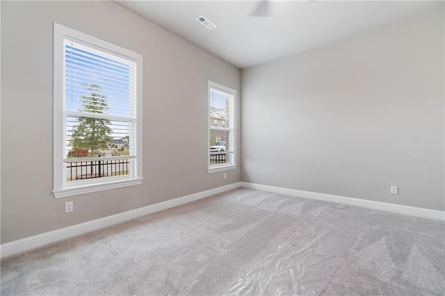 unfurnished room with light colored carpet