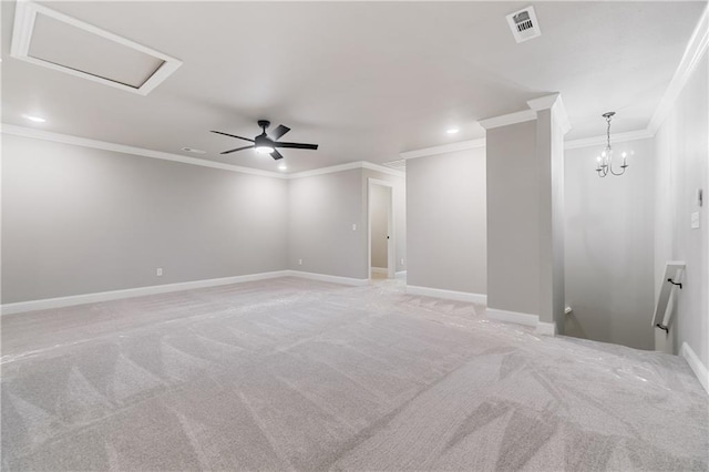 carpeted empty room featuring ceiling fan with notable chandelier and crown molding