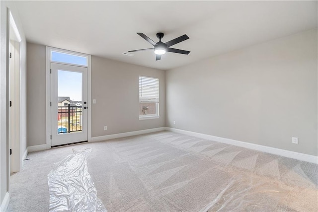 carpeted spare room featuring ceiling fan