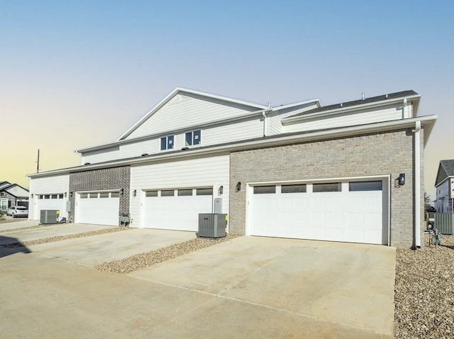 view of front facade featuring central air condition unit and a garage