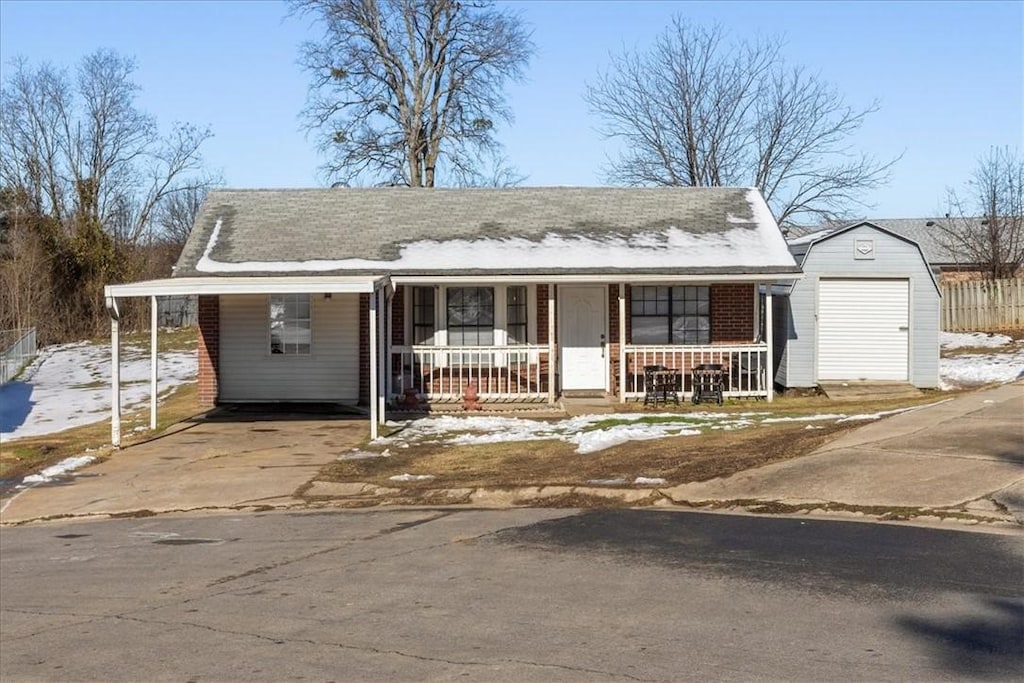 view of front of property with a garage, covered porch, and an outdoor structure