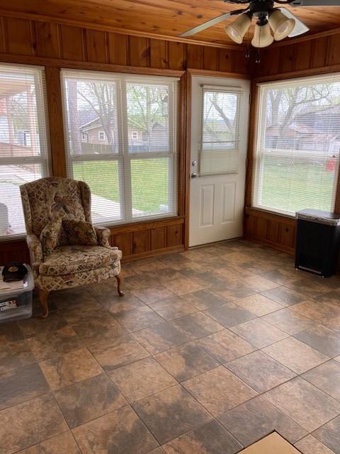 sunroom with wooden ceiling, ceiling fan, and a healthy amount of sunlight