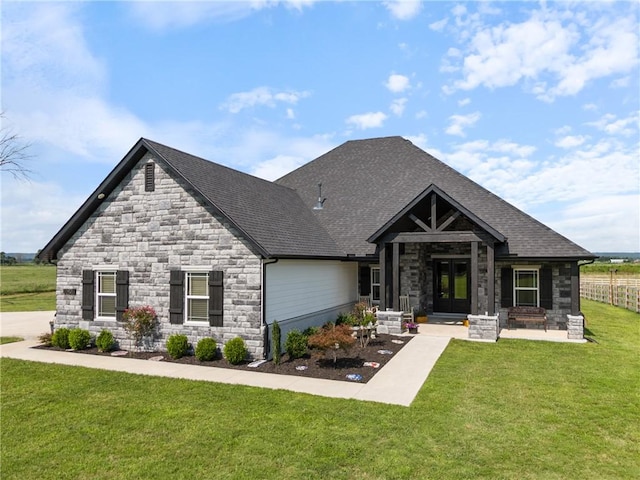 craftsman-style house featuring a front yard and french doors