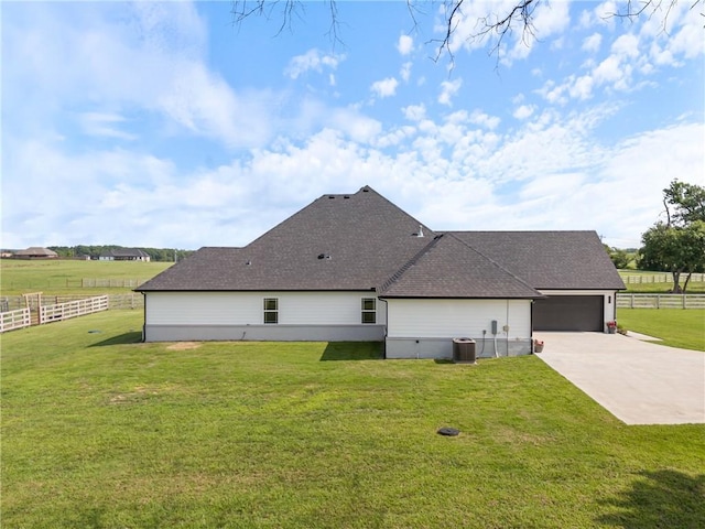 view of home's exterior featuring a rural view, a yard, and a garage