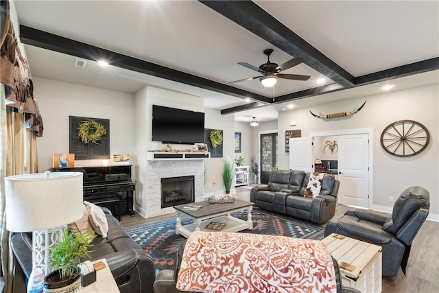 living room with ceiling fan, a fireplace, and hardwood / wood-style flooring