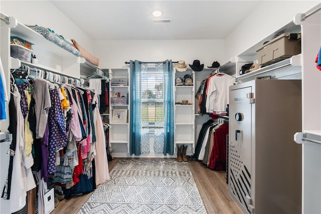 spacious closet with light hardwood / wood-style flooring