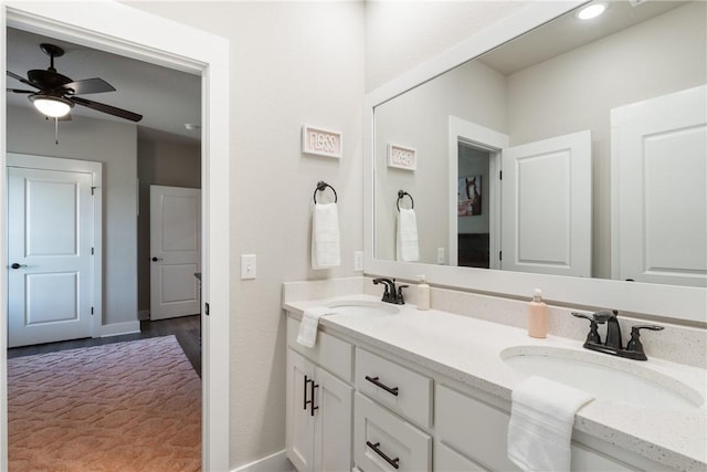 bathroom featuring hardwood / wood-style flooring, ceiling fan, and vanity