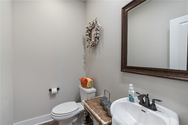 bathroom with sink and toilet