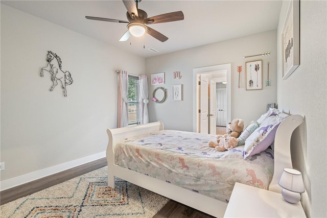 bedroom with ceiling fan and dark hardwood / wood-style floors