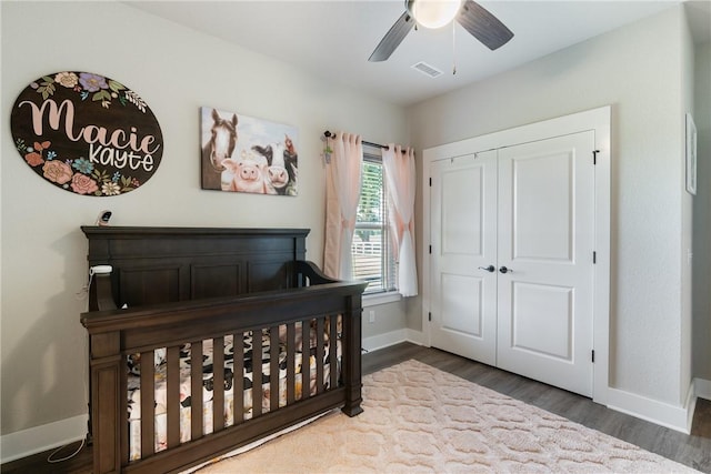 bedroom with ceiling fan, a closet, and dark hardwood / wood-style floors