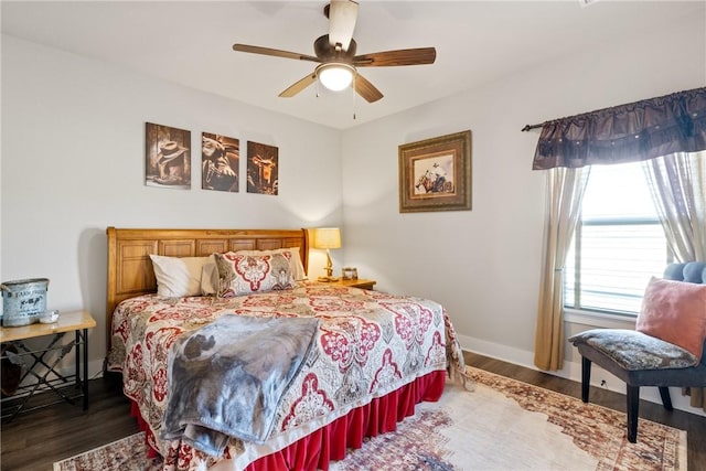 bedroom featuring ceiling fan, dark hardwood / wood-style flooring, and multiple windows