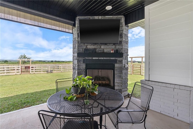 view of patio featuring an outdoor stone fireplace