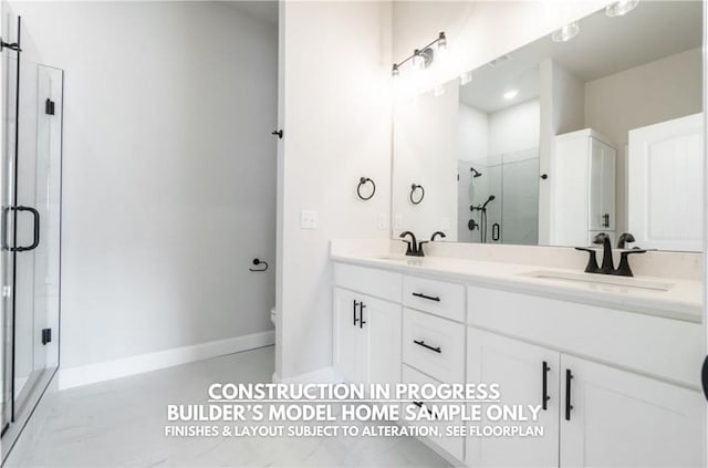 bathroom with toilet, vanity, and a shower with shower door