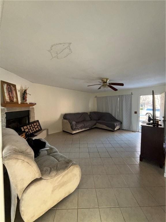 living room featuring ceiling fan and light tile patterned floors