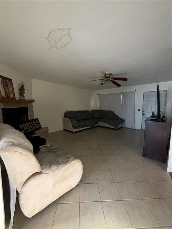 living room with light tile patterned flooring and ceiling fan