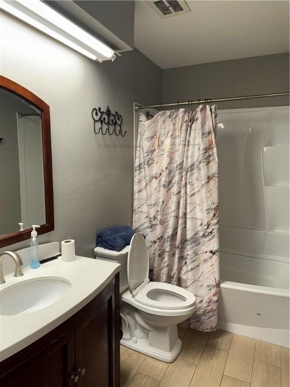 full bathroom featuring toilet, vanity, and shower / bath combo