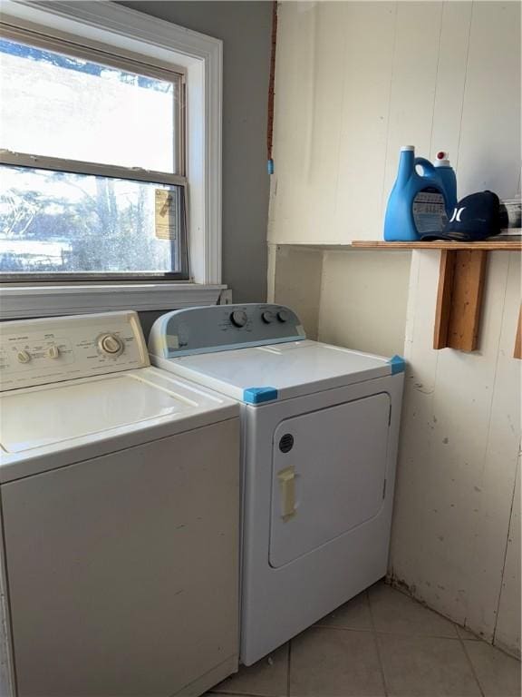 laundry room with washing machine and dryer and light tile patterned floors