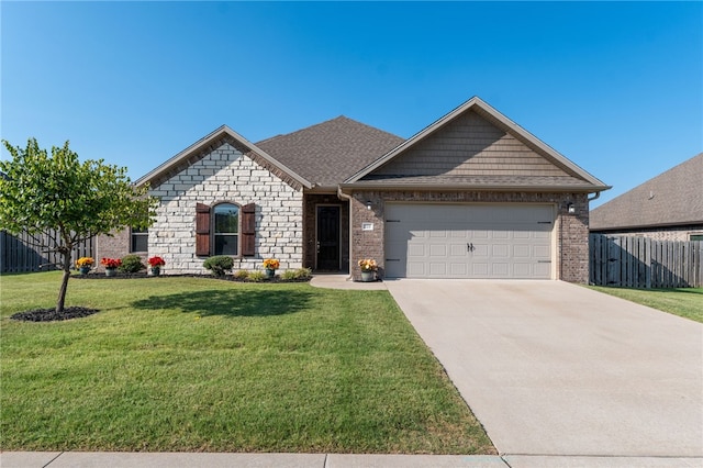 view of front of home with a front lawn and a garage