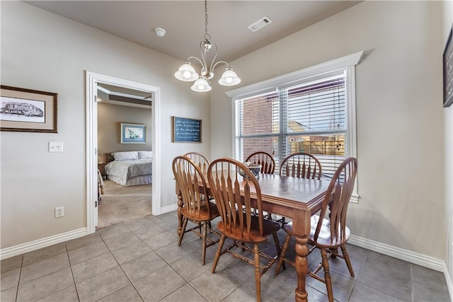 tiled dining space featuring a notable chandelier