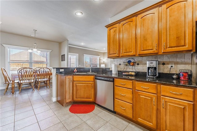 kitchen featuring light tile patterned floors, stainless steel dishwasher, backsplash, dark stone counters, and hanging light fixtures