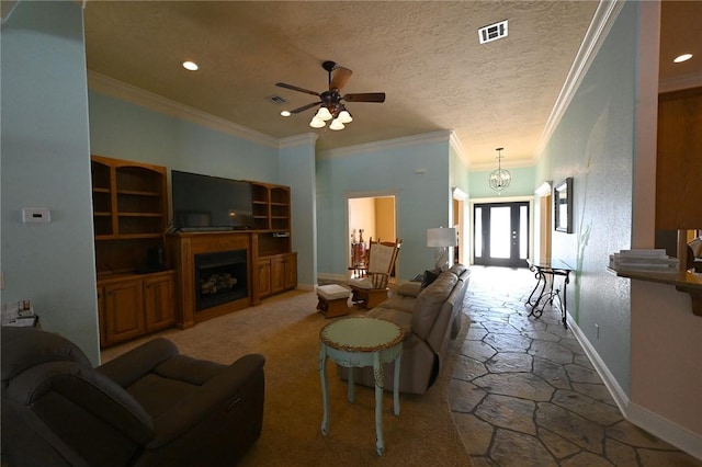 living room with ceiling fan with notable chandelier, a textured ceiling, and crown molding