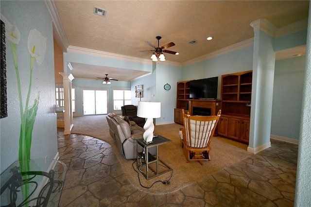 carpeted living room with ceiling fan, ornamental molding, and decorative columns