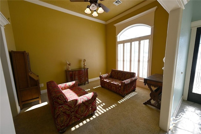 sitting room featuring ornamental molding, ceiling fan, and light carpet