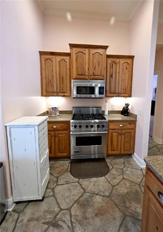 kitchen with appliances with stainless steel finishes and crown molding