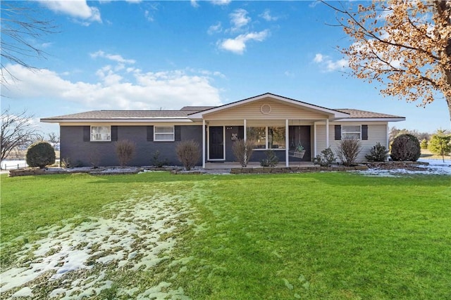 view of front of property with a front lawn and a sunroom