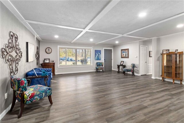 living area featuring dark wood-type flooring, a textured ceiling, beam ceiling, and coffered ceiling