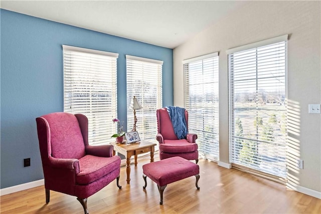 sitting room with baseboards and wood finished floors