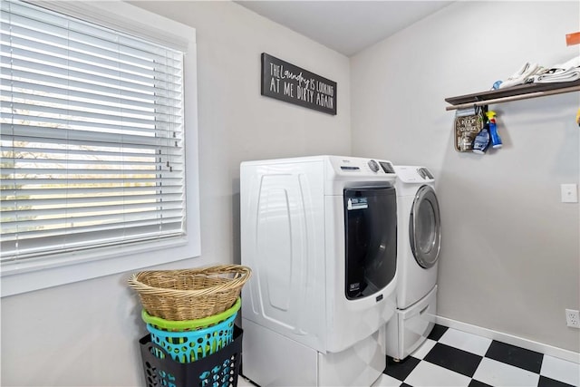 clothes washing area with laundry area, baseboards, separate washer and dryer, and tile patterned floors