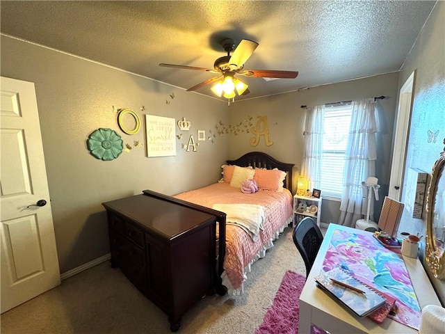 bedroom with a ceiling fan, baseboards, a textured ceiling, light carpet, and a textured wall