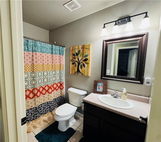 full bath with visible vents, toilet, vanity, tile patterned floors, and a textured ceiling